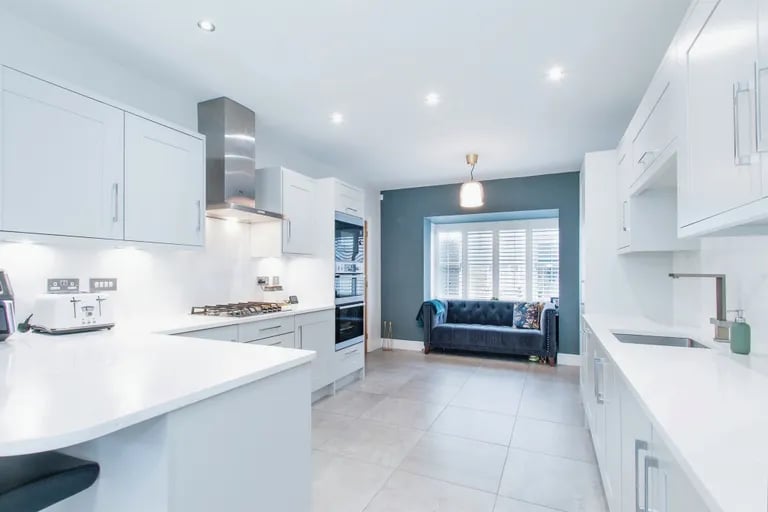 It has spacious and stylish worktops and a breakfast bar.