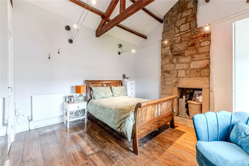 This superb room has high beamed ceilings, exposed stone work and stripped wooden floor.