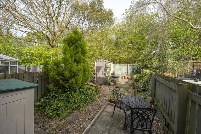 The rear garden is fully enclosed with a wooded view.