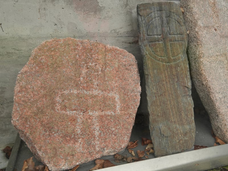 Located just off the Deeside Way between Ballater and Aboyne, in the grounds of the Tullich church and graveyard, lie some extant early medieval carved stones. Some of the stones, which are mostly made from local granite, date back to the Pictish period. There are about 17 on display in a protective shelter, while others are still in place in the church. Most of the stones are personal memorials. Research shows excavations were undertaken in 2013 by Hilary and Charles Murray, who, with Jane Geddes, published a full account of this early medieval church site and its carved stones in 2015. Radiocarbon dates from the graveyard fall in the mid-seventh to late ninth centuries, when there is likely to have been a monastery here.