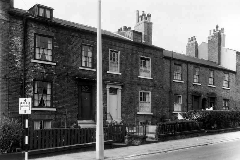 Fenton Street was the edge of the Little Woodhouse area, as it merged with the city centre. It was largely demolished for the building of the Inner Ring Road, only a few shops and the Fenton public house at the Woodhouse Lane end remain. These were back-to-back houses, the rear of the street was numbered in staggered order with the front. On the left is a road sign for the A660 Otley Road via Woodhouse Lane. Pictured in September 1960.
