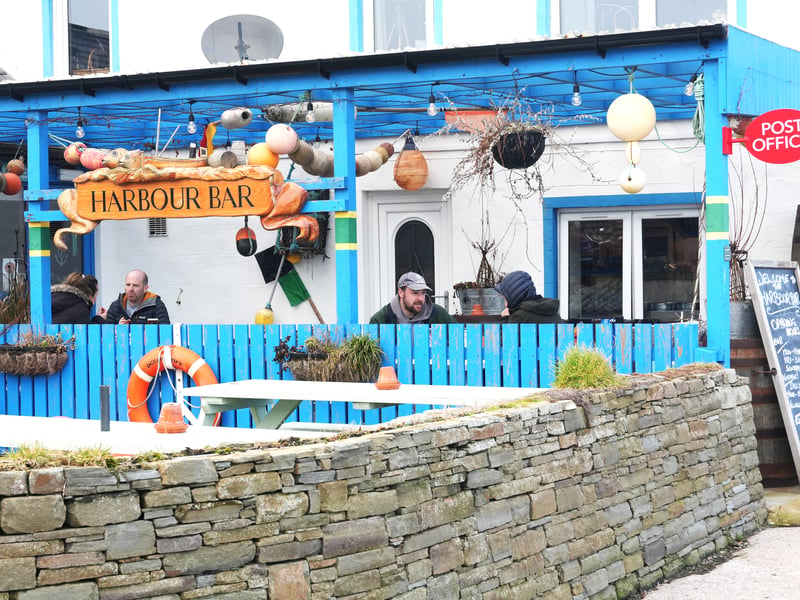 Down on the harbour front in Gourdon, a small fishing village that sits between Inverbervie and Johnsaven, you can find the Harbour Bar. I first heard about the pub when I was sitting in a cafe in Stonehaven waiting for my phone to charge and a woman started asking me what I was up to. She recommended walking to Gourdon, and said the local pub functions as a post office after the village's one shut down. That's when I knew I wanted to visit it.