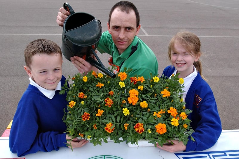 B&Q environmental champion Graeme Atkinson was happy to help with a spruce-up of the plants at JFK Primary School.
Keiron Robinson and Sophie Jordan helped him water the plants.