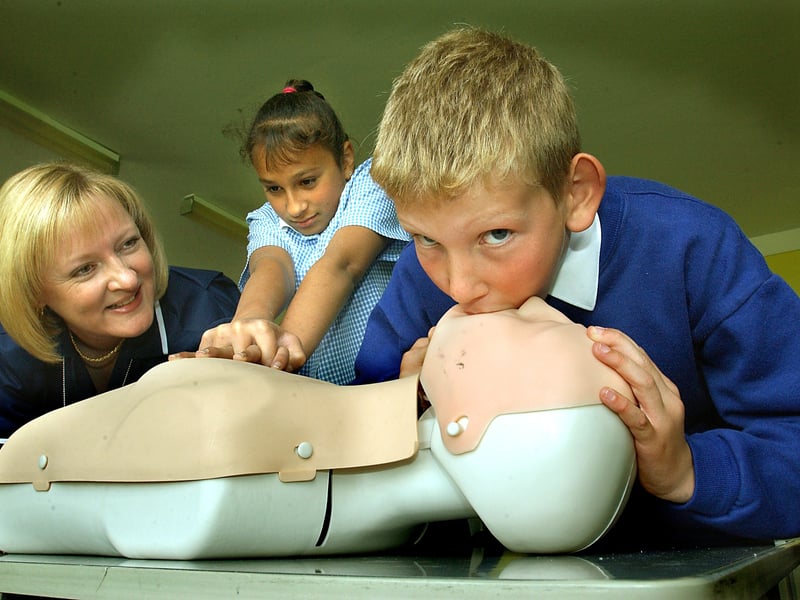 NHS staff demonstrating life-saving techniques at St Cuthbert's Catholic Primary School, Blackpool. Karen Hodgson (Nurse Training Co-ordinator, Fylde Primary Care Trust) watches Nathan Gourley and Basia Sooky (both 10) trying resuscitation techniques