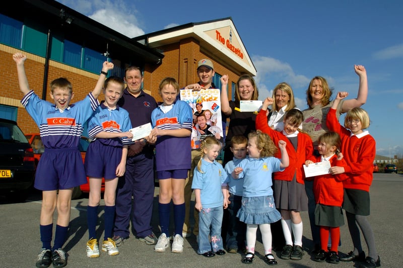 The three Cash4Kidz winners receive their cheques for £3000 each at the Gazette office in Blackpool. Dominos Pizza marketing manager Janine Sharratt  (back, second from right) and Dominos Pizza Ansdell branch manager Steven Martin (centre, back) presented the cheques to representatives of St John's Catholic Primary School, Dunes Day Nursery and Blackpool Scorpions U11 rugby team
