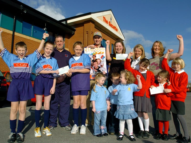 The three Cash4Kidz winners receive their cheques for £3000 each at the Gazette office in Blackpool. Dominos Pizza marketing manager Janine Sharratt  (back, second from right) and Dominos Pizza Ansdell branch manager Steven Martin (centre, back) presented the cheques to representatives of St John's Catholic Primary School, Dunes Day Nursery and Blackpool Scorpions U11 rugby team