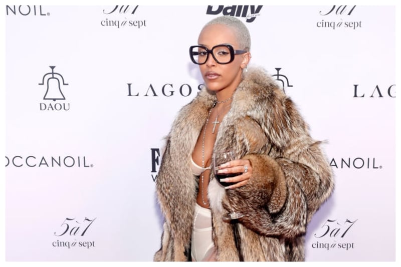 With a fur coat over a lingerie style outfit plus a suitcase as a prop with a glass of red wine, Doja Cat's outfit did unfortunately fail to hit the fashion mark 