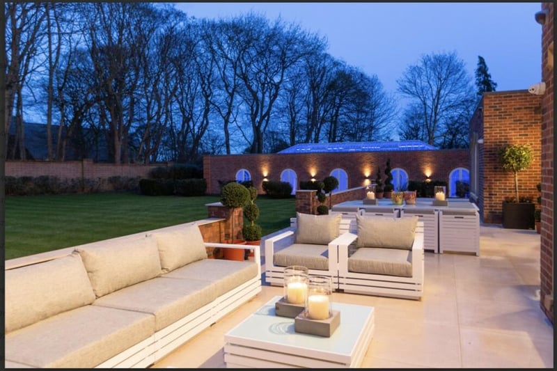 Large walled terrace and meticulously landscaped gardens.