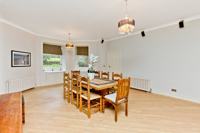 On the opposite side of the hall, the southwest-facing dining room provides an equally spacious reception area and the flexibility of use for formal gatherings and casual, everyday living. It has a neutral backdrop and a traditional-inspired feature wall, as well as a hardwood floor for easy upkeep. A multi-fuel stove completes the space, ensuring a cosy environment for dinner parties.
