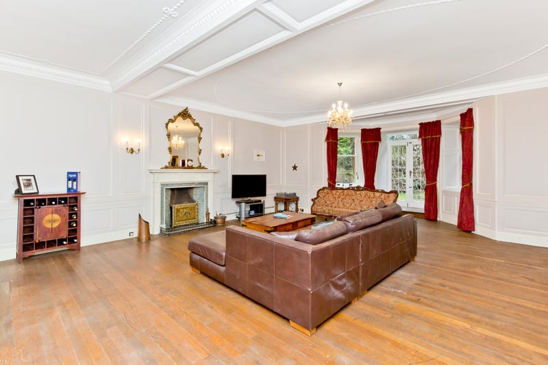 The living room immediately catches the eye, with its expansive dimensions and characterful period details, including highly ornate cornicing, decorative ceiling plaster work, and traditional wall panelling. The elegant look is further enhanced by white décor and stripped wooden floorboards, whilst a magnificent working open fireplace creates the most eye-catching focal point. The room has a walk-in storage cupboard and it is brightly illuminated; plus, it flows out into the rear garden via French doors.