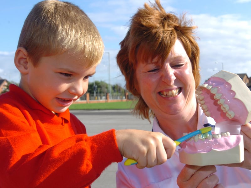 Children at Our Lady Assumption Catholic Primary School in Blackpool are being shown how to brush their teeth by Dental Health Educator for Blackpool PCT Helen Kellett. With Helen is Ben Cardwell (5)