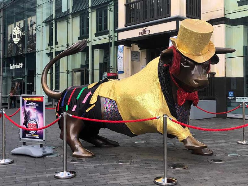 Time warp! The bull donned a gold top hat, blazer, and red hair, ready to do the “Time Warp” dance.