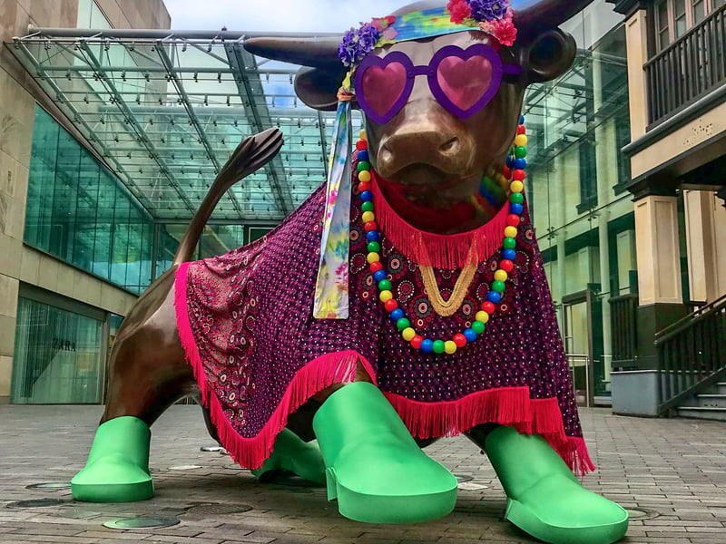 Heart-shaped glasses, green boots, beads, and a psychedelic poncho—groovy, man!