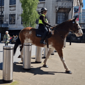 Two police officers patrol on Tudor Square in Sheffield city centre during World Snooker.
