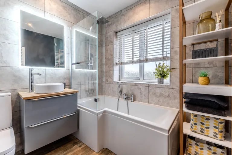 The modern house bathroom has a bathtub with shower over.