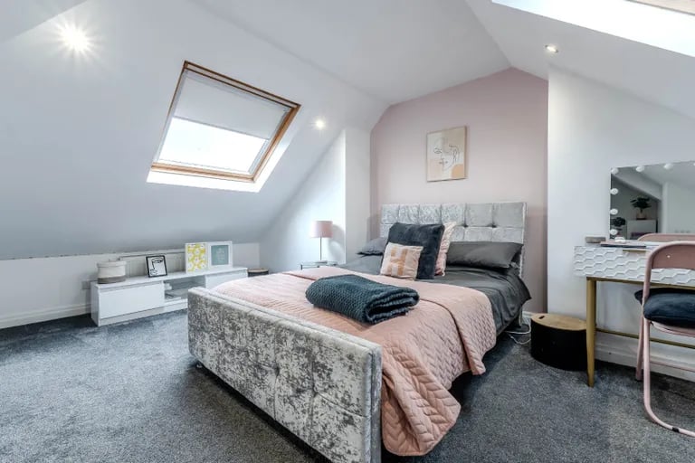 On the second floor is another large bedroom with skylights as well as storage space.