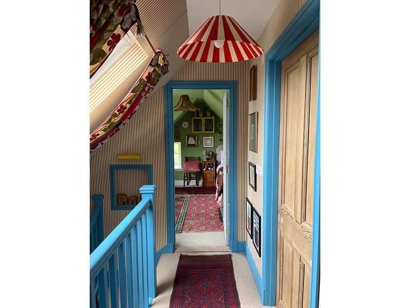 The hallway at Quiney Cottage demonstrates Rachel's love of bold patterns and bright colours.