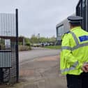Birley Academy, in Birley Lane, Sheffield, South Yorkshire, is reportedly under lockdown this morning after an incident in which three people were injured. A boy, 17, has been arrested for attempted murder. Picture shows a police officer guarding the school's main gate.