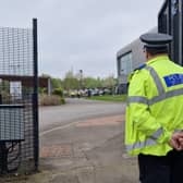 Birley Academy, in Birley Lane, Sheffield, South Yorkshire, is reportedly under lockdown this morning after an incident in which three people were injured. A boy, 17, has been arrested for attempted murder. Picture shows a police officer guarding the school's main gate.