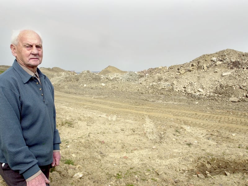 This is Fred Brown who had spent the last two years
construction worker pile hundreds of tons of soil in a field near the bottom of his garden on Leysholme Cresent. Pictured in April 2002.