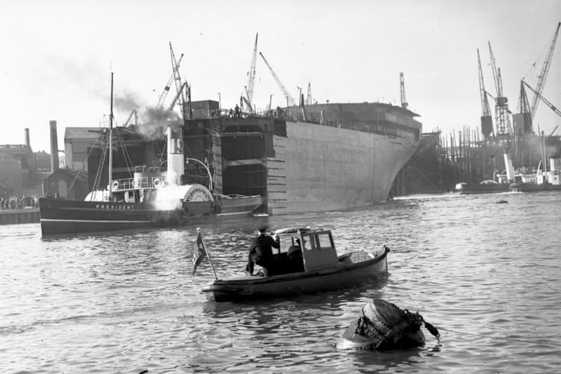 The launch of half a ship from the yard of John Crown & Sons in 1954.
The rest was being worked on at the Strand Quay at the time.