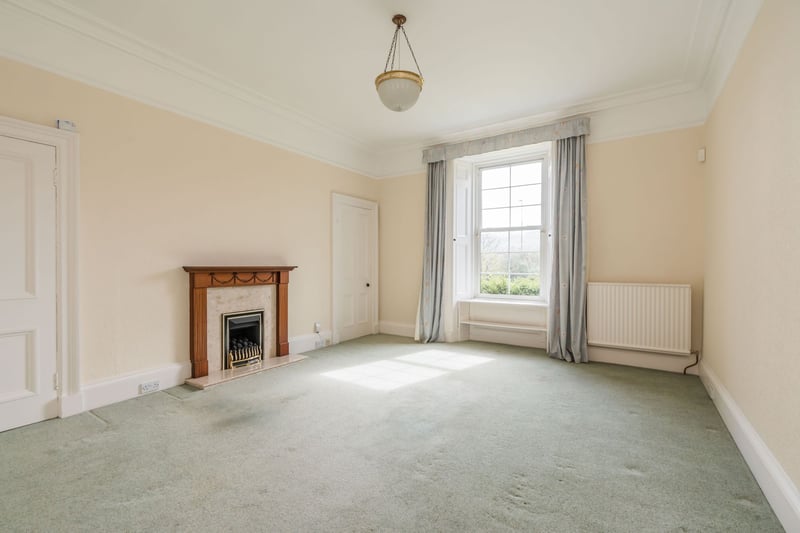 The property's spacious south facing living room with focal fireplace.