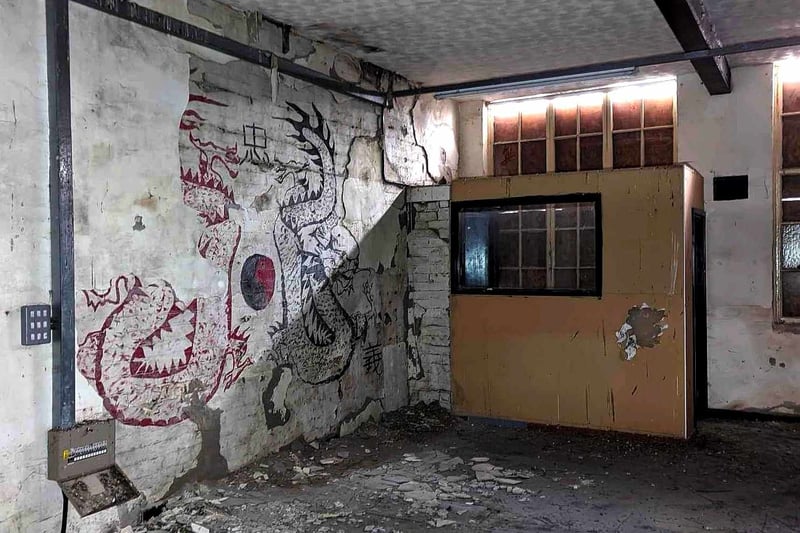 Designs on the walls of the abandoned building can still be made out