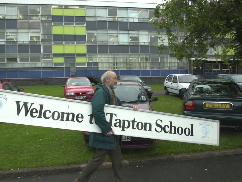Pictured at the old Tapton school, on Darwin Lane, Crosspool, is deputy headteacher Richard Storer, as he carries the old school sign away to be fitted at the new school building.
