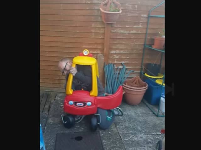 A dad finds it impossible to get out of his toddler's Little Tikes car.