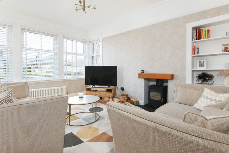 The Duddingston property's bright and airy living room, with feature wood-burning stove.