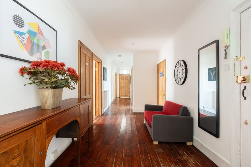 The only property on the top floor, a well-kept communal stair with secure entry system leads up to the front door, which opens into a large reception hallway with extensive built-in storage space and a guest WC.