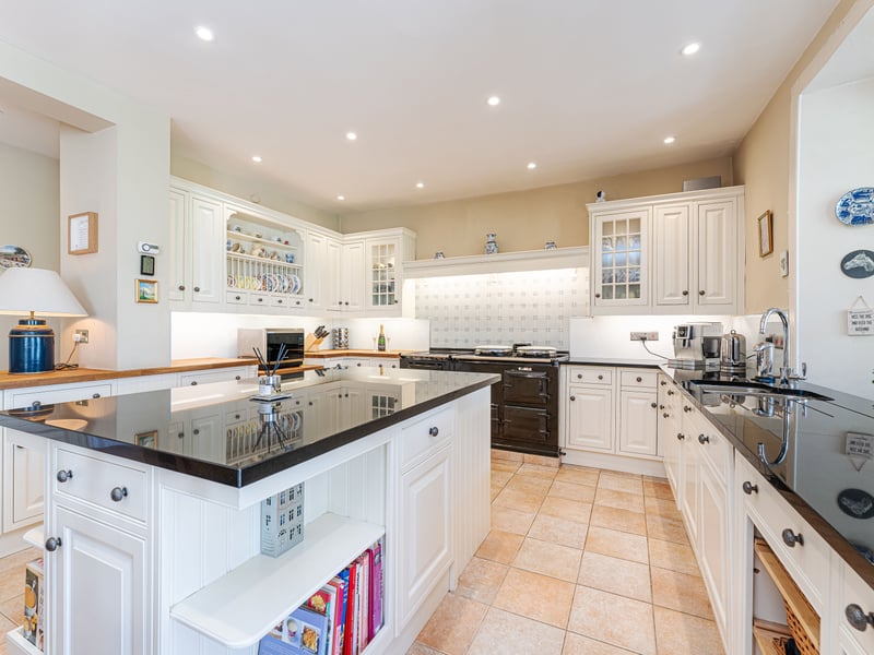 The kitchen boasts an Aga range and a good-sized island.