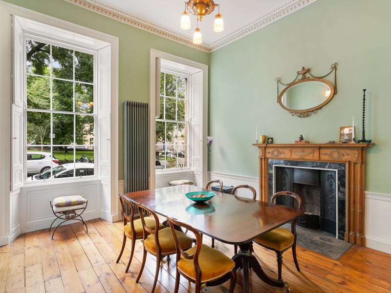 The light an airy formal dining room has ample space for guests.
