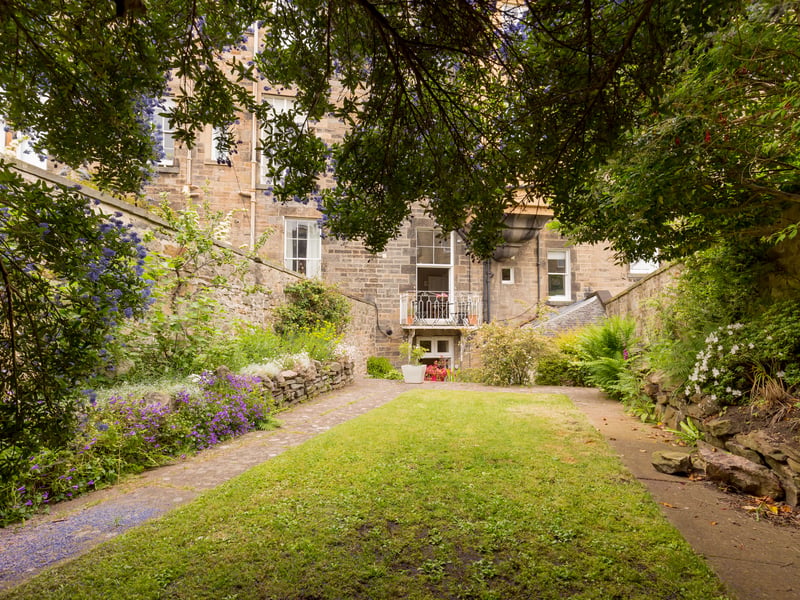 Exterior: The property has three useful under-pavement cellars for storage, and a west-facing rear garden with lawns and colourful borders.
