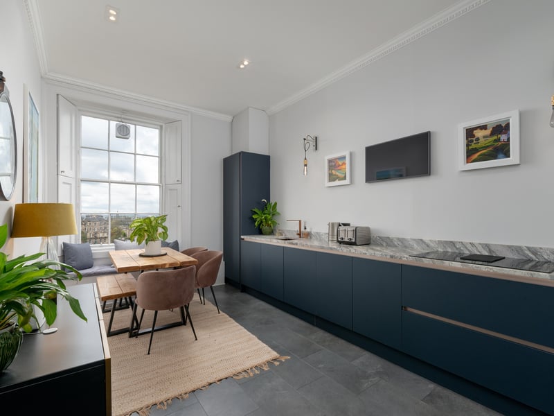 Interior: The apartment is entered via a shared entrance and features a large living room, along with a study, drawing room/fifth bedroom, and a sleek kitchen. The rest of the sleeping quarters are up a level.