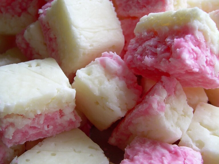 This colourful sweet was a favourite, sometimes made at home, on Sunday evenings. The pink and white layers added a fun visual element to the sweet, coconutty treat.