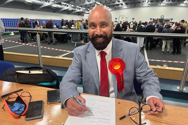 Javaid Akhtar signs the declaration after winning the seat in Little London and Woodhouse.