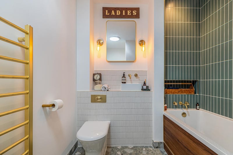 There is a beautiful main bathroom comprising white three-piece suite and contrasting tiling around bath and vanity area, and there is a large walk-in storage cupboard off set.