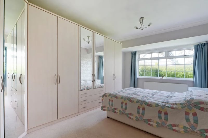 The master bedroom is described as 'generously proportioned', and the window overlooks a cherry blossom tree.