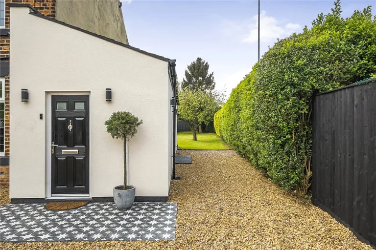 To the front, the property enjoys a pebbled driveway with workshop.
