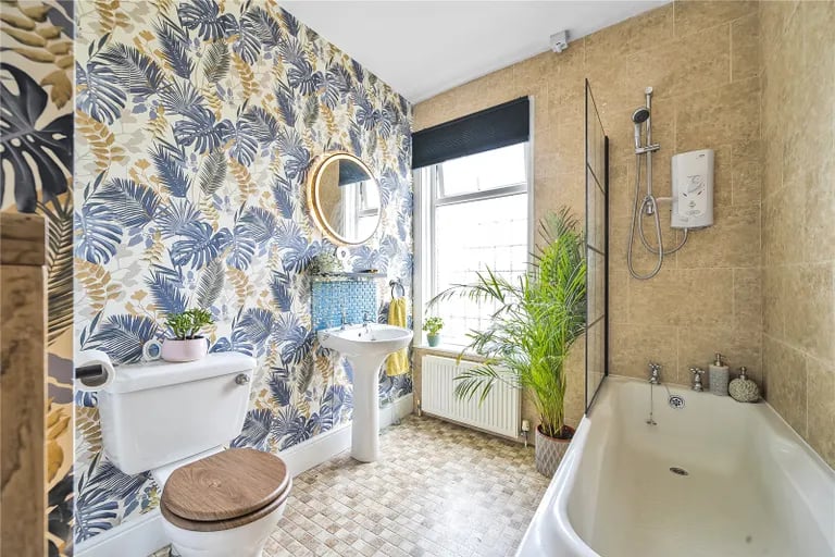 The family bathroom oozes character and features a good-size bath.