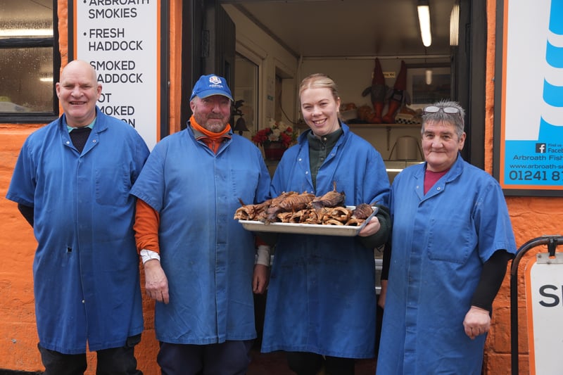 (From left to right) Colin Mudie, Campbell Scott, Lauren Angus and Elaine Green showed me around Abroath Fisheries where they make the famous smokies. I saw the process from start to finish with Campbell preparing the fresh Haddock delivered on a ferry from Shetland before they are tied in pairs at the tails over a beam to then dangle over a fire in a barrel and smoked. The soft, white fish turns a coppery colour on the outside as the flesh develops a melt-in-your mouth buttery flavour with a hint of smoke. It's no surprise there is a resident seagull, Elvis, who sits patiently on a nearby rooftop waiting for any scraps to be thrown his way. 
https://www.scotsman.com/hays-way/hays-way-two-smokies-swinging-from-my-rucksack-a-perfect-snack-and-social-deterrent-4571847