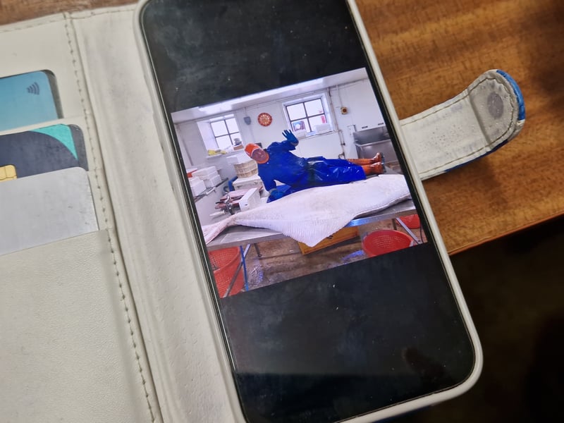 Campbell said one of his deliveries shot up in cost to over £1,000 and he couldn't work out why. That was until it arrived and a halibut bigger than him was hauled out the box. This is a picture on his phone of him lying next to the enormous sea creature delivered that day.