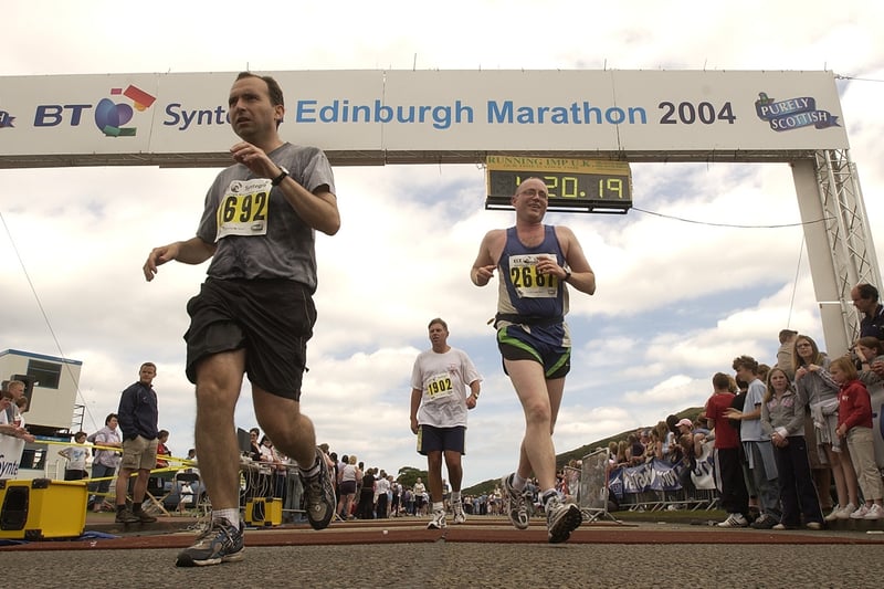 Runners cross the finish line at the end of the gruelling marathon at Holyrood Park in Edinburgh in 2004.