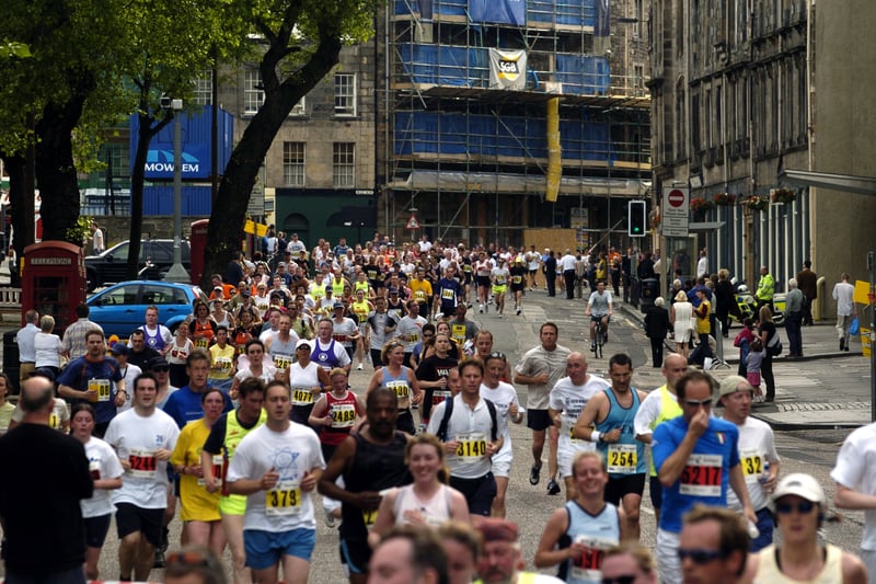 Edinburgh Marathon 2004 runners are pictured filing though the Grassmarket and its many pubs during the 26.2 miles run.