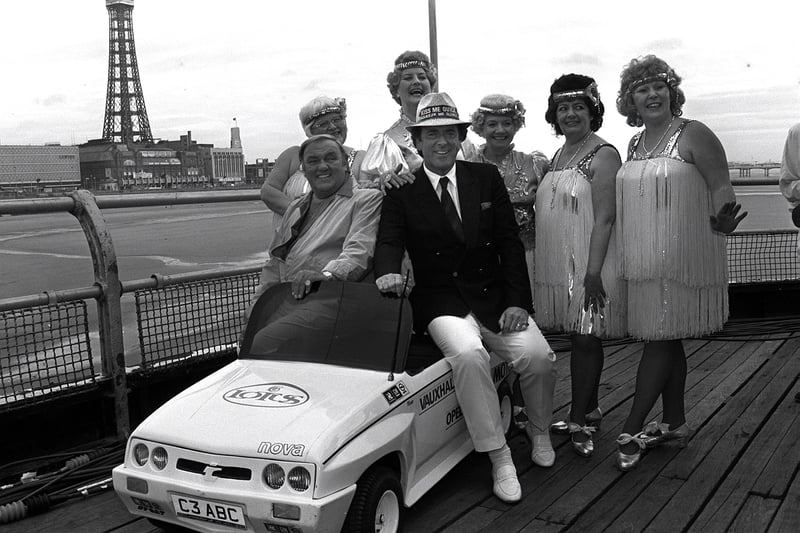Terry Wogan, Les Dawson and the Roly Poly's pose on a miniature car to promote a visit to the North Pier