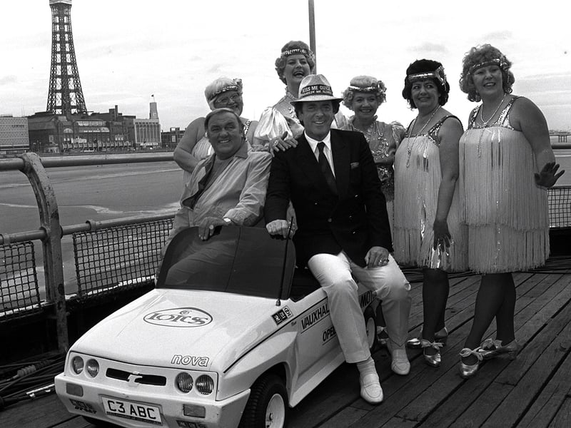 Terry Wogan, Les Dawson and the Roly Poly's pose on a miniature car to promote a visit to the North Pier