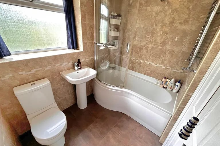 The family bathroom is also on the first floor and has a P-shaped bathtub with shower over.