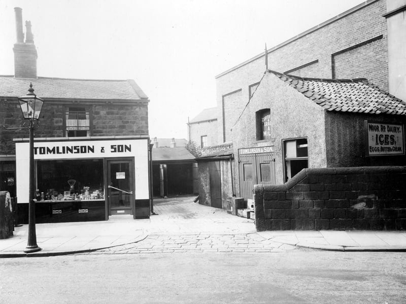 Shop, yard and dairy on Moor Road in August 1935. Owned by T. Tomlinson and son, also Frank B. Tomlinson at this address. The modern shop front had recently been added. Dealing in milk, butter, cream and eggs, also famed locally for home-made ice-cream. The building on the right was an electricity sub-station built in the early 1930s. In the 1980s, dairy property was converted into flats.