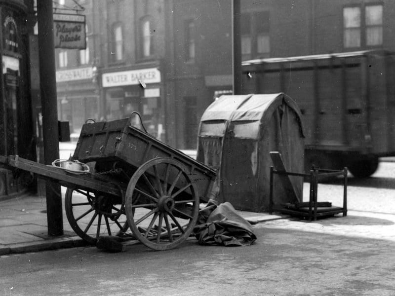 Handcart and telephone repair shelter on junction of Regent Park Avenue with Headingley Lane. William Crosswaite butchers and Walter Barker, grocers can be seen on the right. Pictured in July 1936.